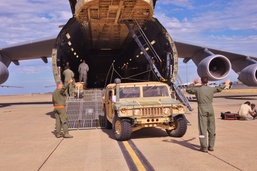 Airmen guide Soldiers off of C-5 aircraft at Moffett Field
