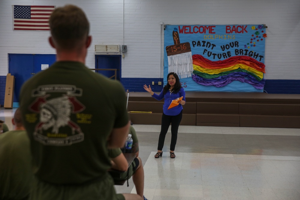 Helping hands: U.S. Marines and sailors assist in painting school