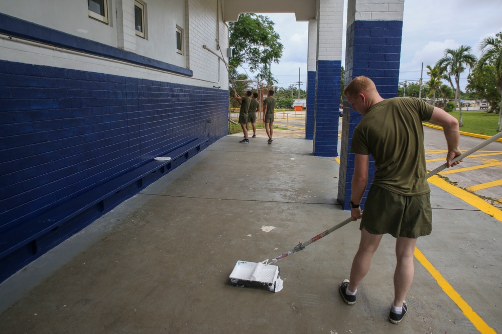 Helping hands: U.S. Marines and sailors assist in painting school