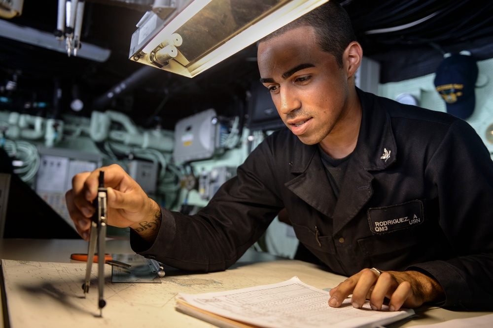 USS Green Bay Sailor plots a course
