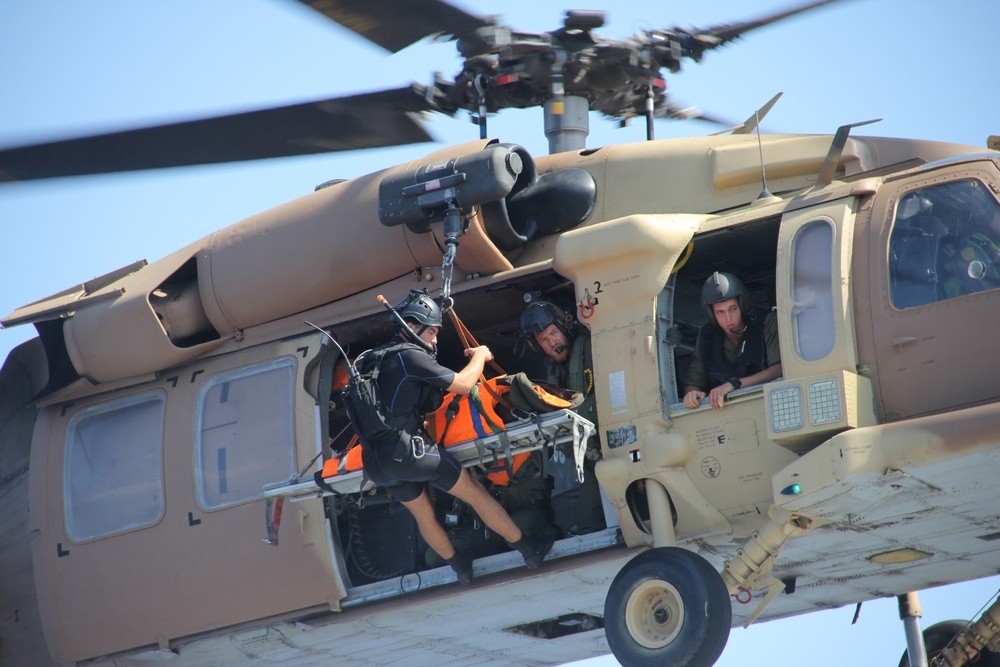 Rescue swimmer descends to USS Porter