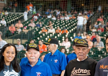 US Coast Guardsman escort veterans at baseball game