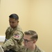 US Navy personnel at Role 3 MMU provide patient care, Kandahar Airfield