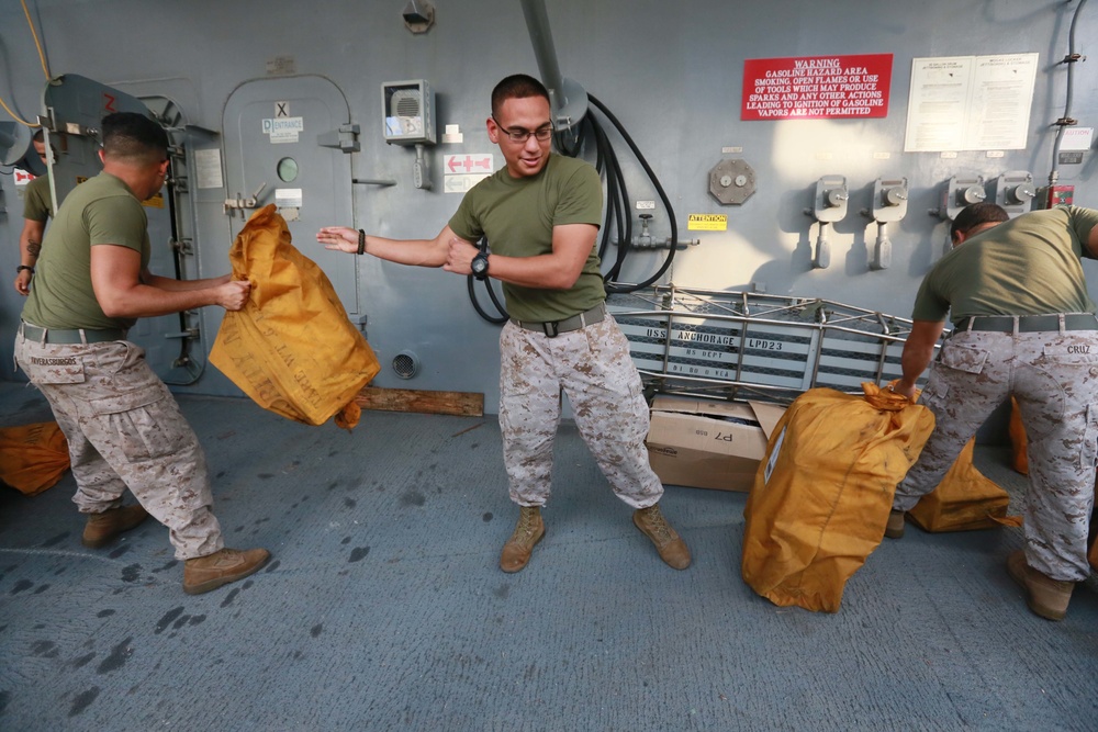 Mail call: U.S. Marines and Sailors sort packages