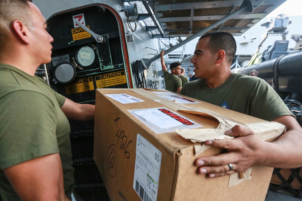 Mail call: U.S. Marines and Sailors sort packages