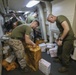 Mail call: U.S. Marines and Sailors sort packages