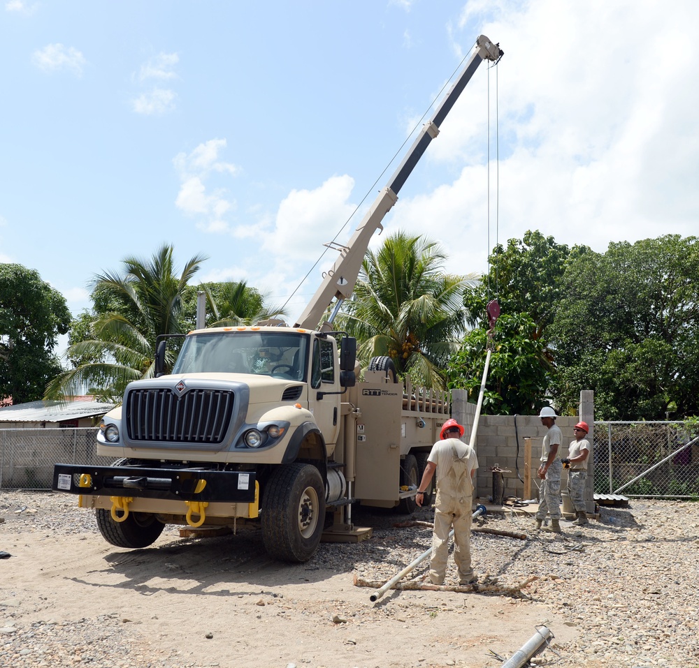 Well drillers install new pump motor and test pumps