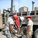 Well drillers install new pump motor and test pumps