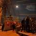 Coast Guard Cutter sails under a full moon