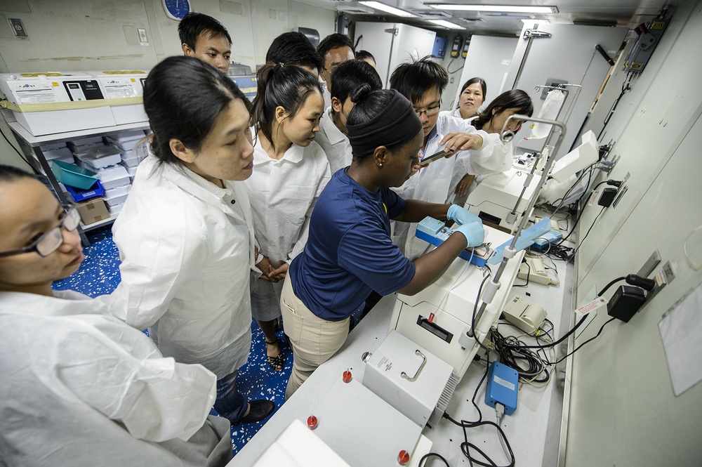 Vietnamese medical laboratory technicians train with US Navy medical personnel during blood safety workshop aboard USNS Mercy
