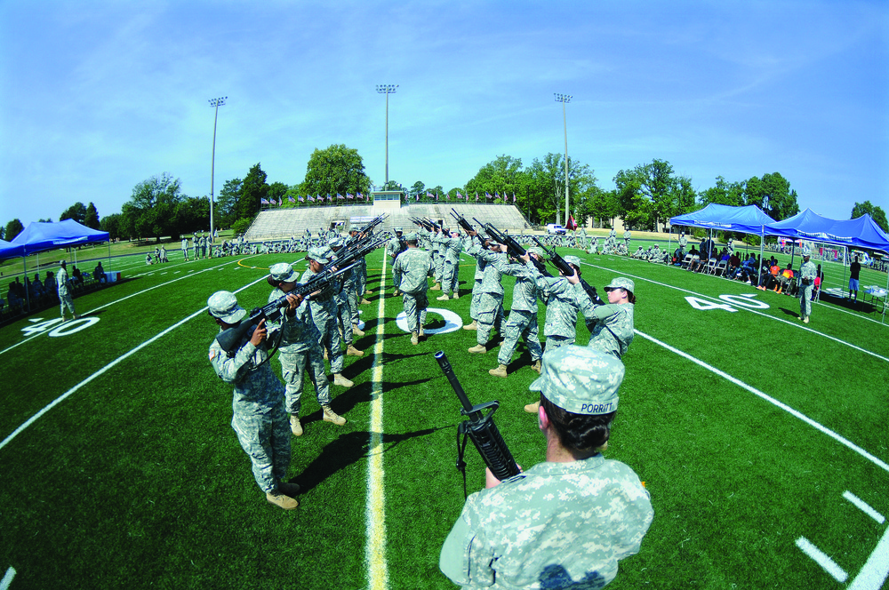 Soldiers point weapons skyward during Fort Lee drill and ceremony event
