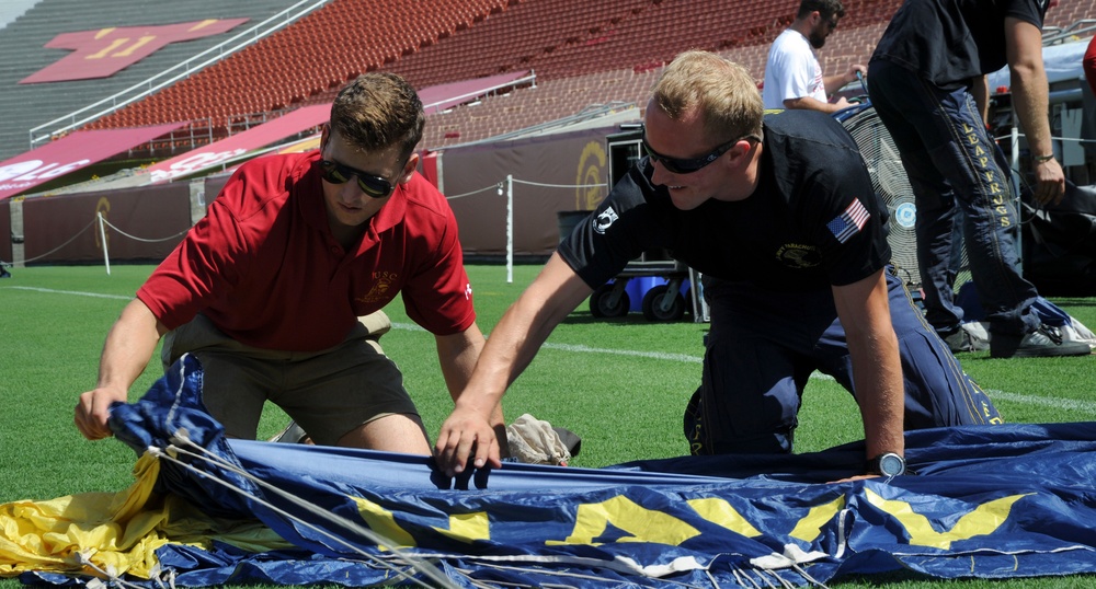 Leap Frogs member shows ROTC member how to pack parachute