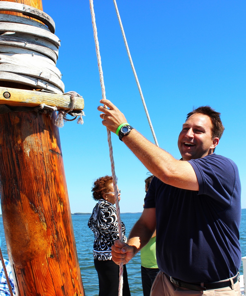 Rep. Johnny Mautz hoists the sails aboard the REBECCA T. RUARK for oyster restoration completion event