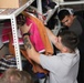 Marines, sailors don their aprons, serve at Sicilian soup kitchen