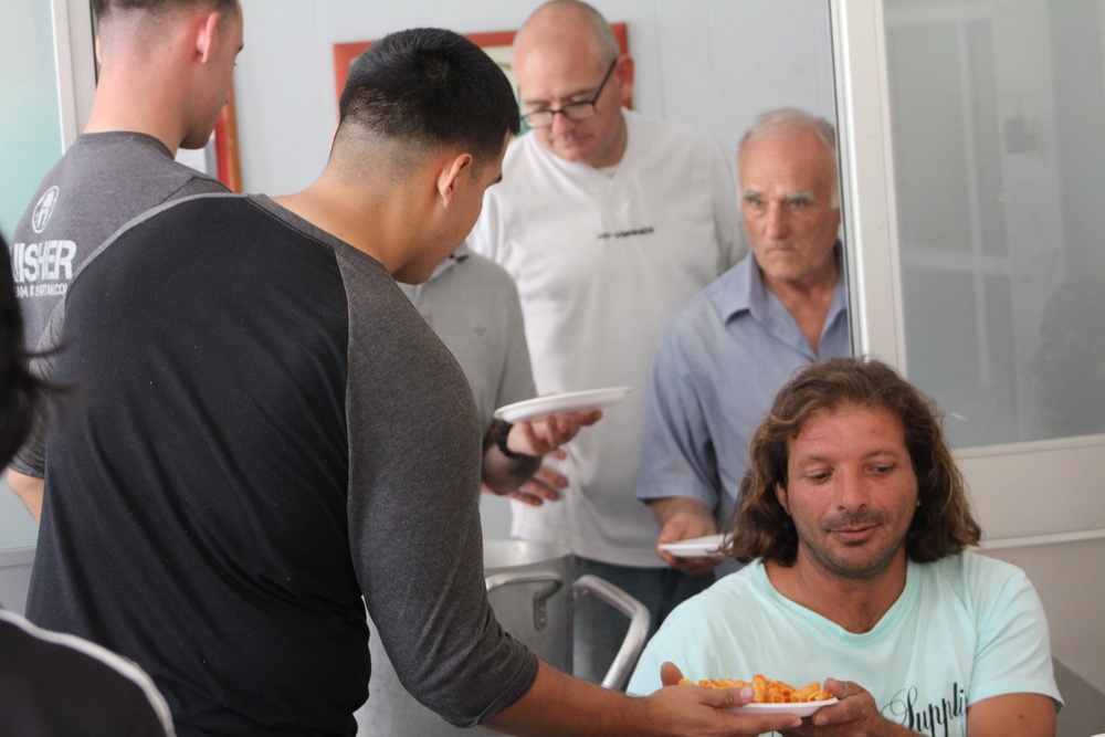 Marines, sailors don their aprons, serve at Sicilian soup kitchen