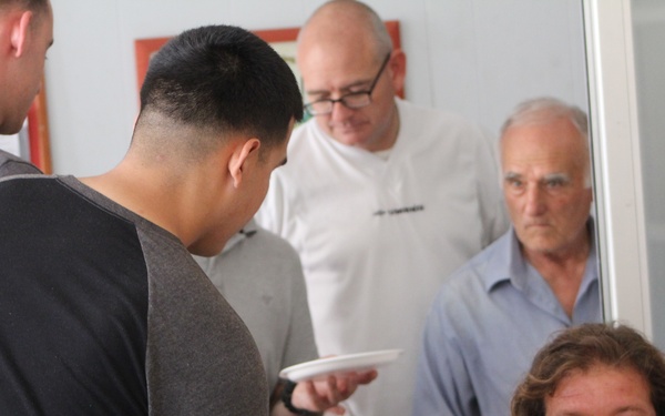 Marines, sailors don their aprons, serve at Sicilian soup kitchen
