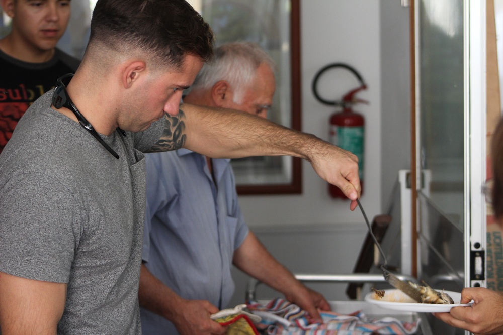 Marines, sailors don their aprons, serve at Sicilian soup kitchen