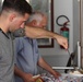 Marines, sailors don their aprons, serve at Sicilian soup kitchen