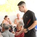 Marines, sailors don their aprons, serve at Sicilian soup kitchen