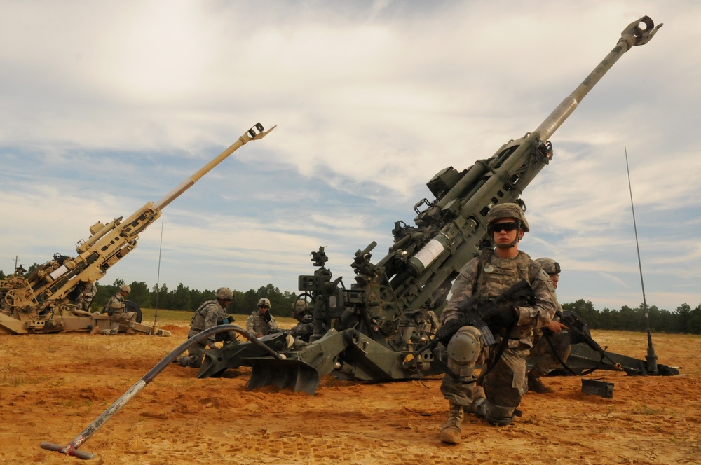 An airborne artilleryman, assigned to 2nd Battalion, 319th Airborne Field Artillery Regiment, 82nd Airborne Division Artillery, pulls security for his M777A2 howitzer 