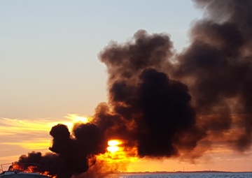 Boat burns at sunset off Galveston
