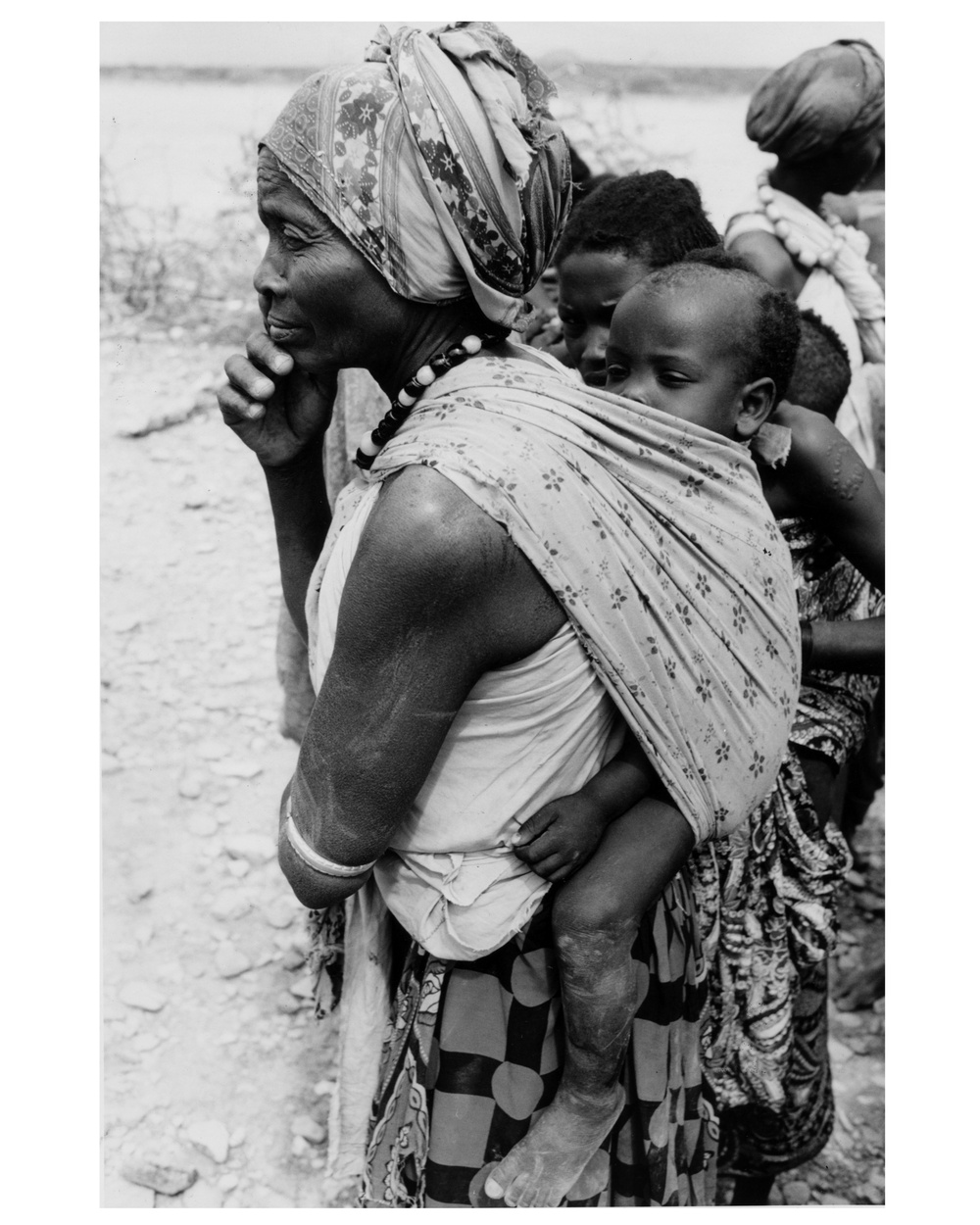 Woman with Large Child on her Back