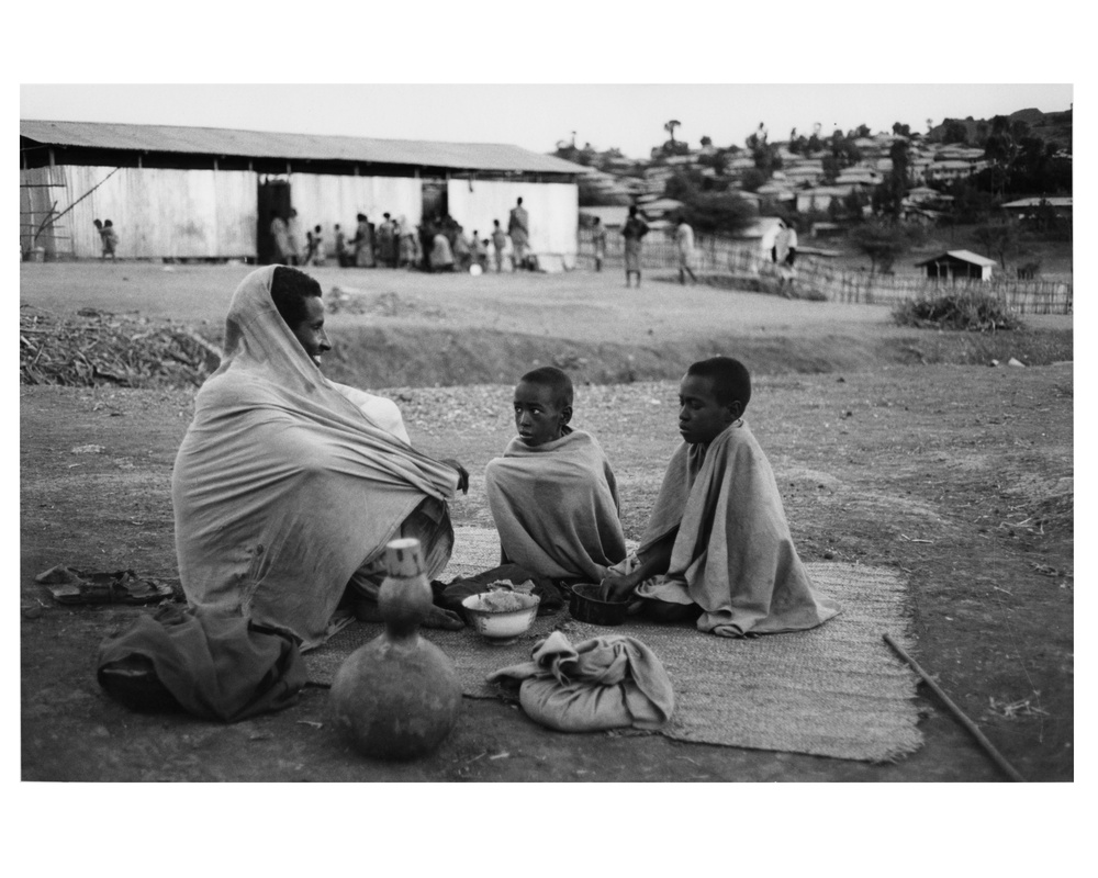 Man and Children in Refugee Camp