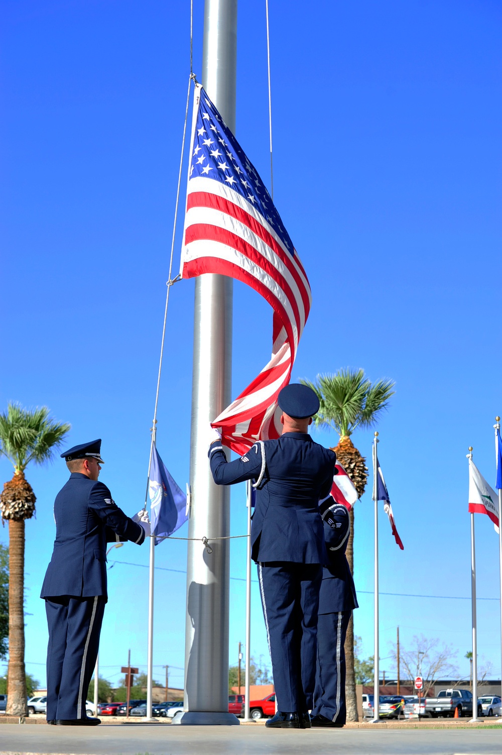 Luke Honor Guard members lower American flag