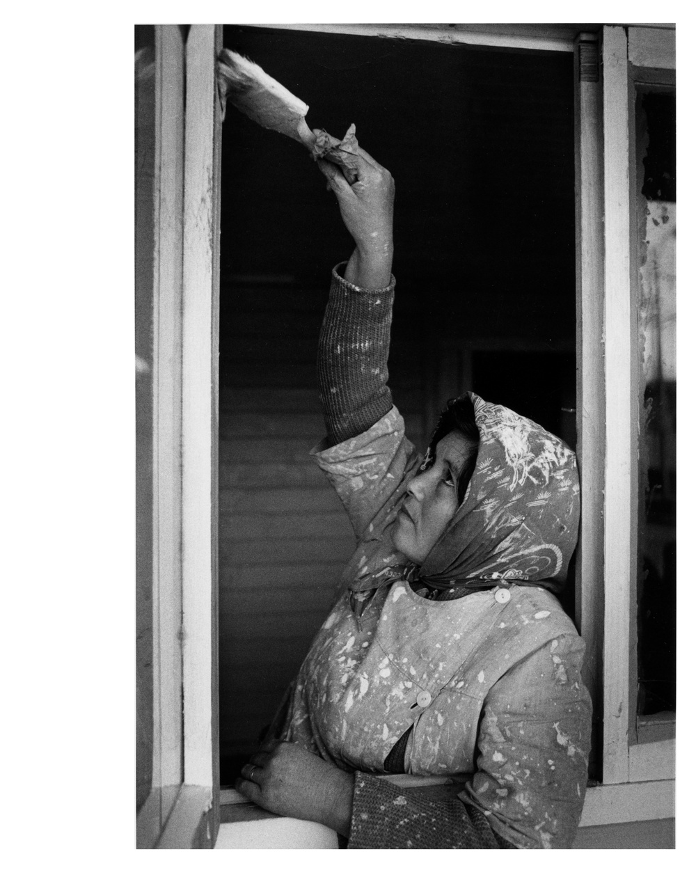 A Chilean housewife paints the new house which she will soon move into - Chile