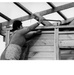 A Chilean housewife wields a crowbar as she works on new house which she and her family will soon move into - Chile