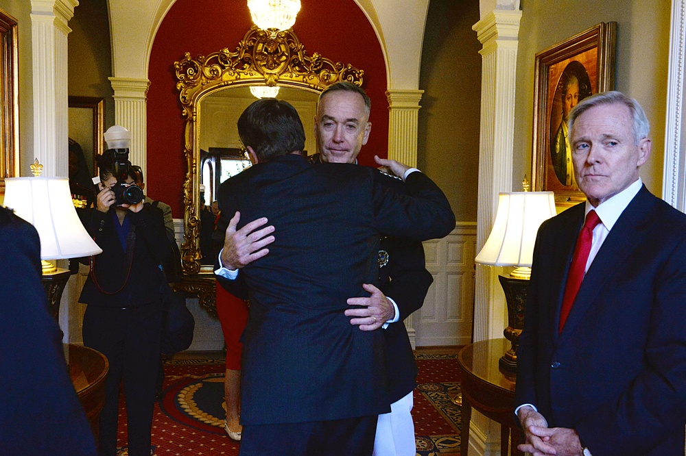 Secretary of defense shares an embrace with outgoing commandant, Marine Gen. Joseph F. Dunford Jr.