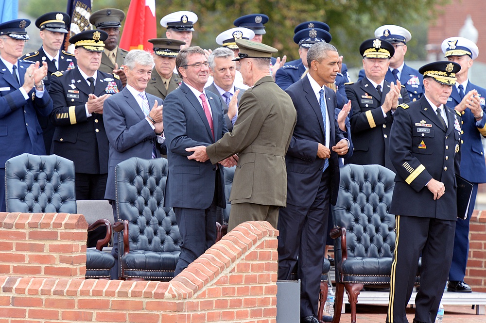 Secretary of defense shakes hands with the new chairman of the Joint Chiefs of Staff