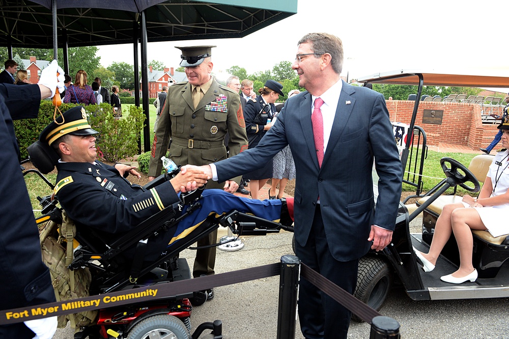 Secretary of defense shakes hands with Capt. Luis Avila