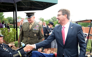 Secretary of defense shakes hands with Capt. Luis Avila