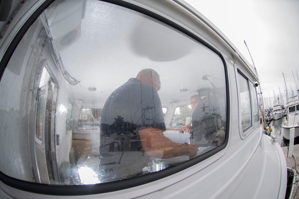 A Coast Guard marine inspector checks for proper documentation