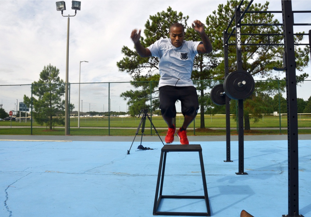 Petty Officer 1st Class Raymond Concepcion demonstrates workout