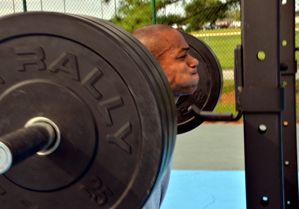 Petty Officer 1st Class Raymond Concepcion demonstrates workout