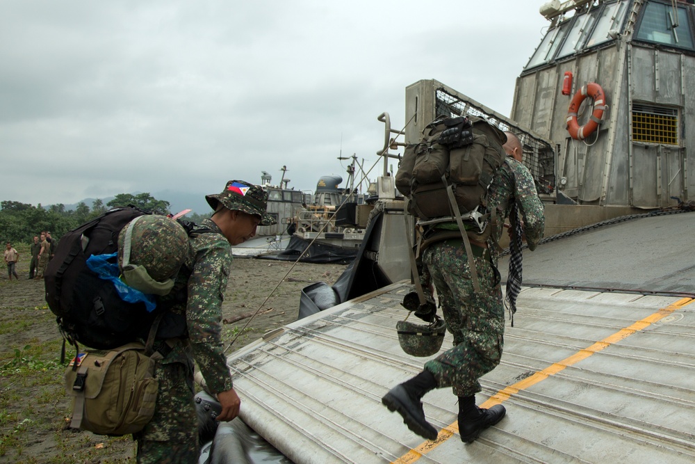 Filipinos get a ride in Marine amphibious landing craft