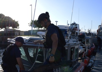 Maritime Safety and Security Team 91107 escorts cruise ship in Honolulu Harbor