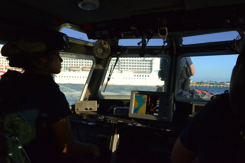 Maritime Safety and Security Team 91107 escorts cruise ship in Honolulu Harbor
