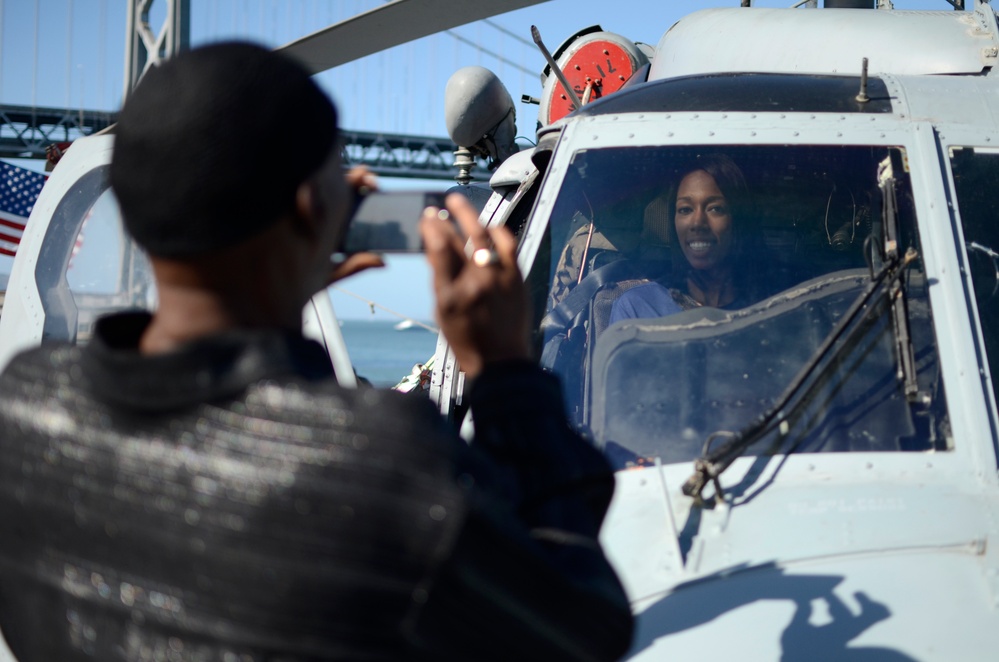 Future Sailor poses for photo aboard USS Somerset