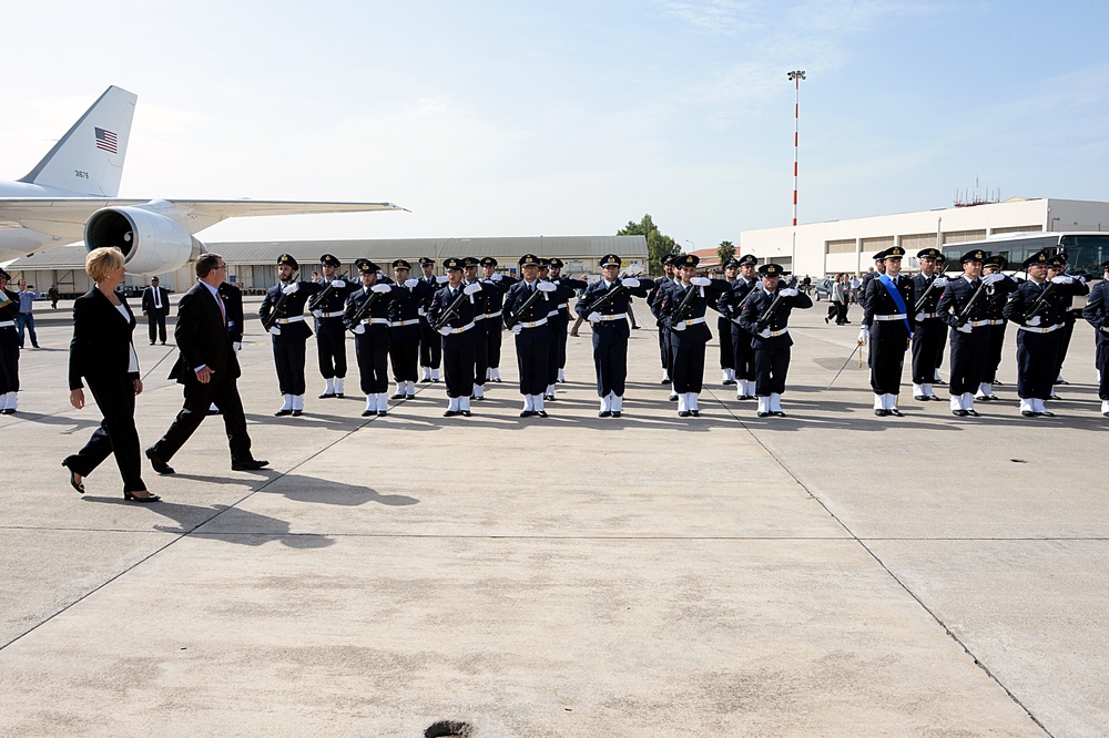 Secretary of defense and Italian Defense Minister Roberta Pinotti pass in front of troops during the honors arrival ceremony