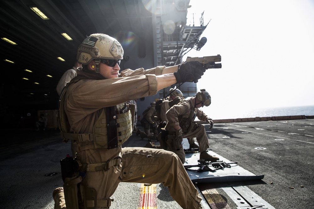 U.S. Marines fatigue bodies, fire weapons