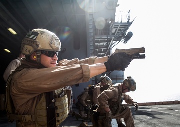 U.S. Marines fatigue bodies, fire weapons