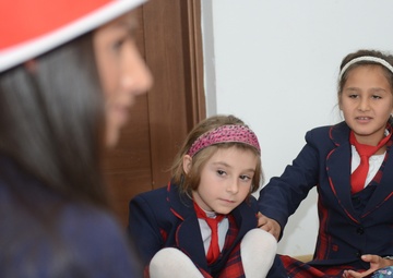 NSF Deveselu Sailors read to school children