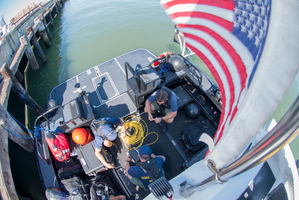 Regional Dive Locker West Coast Guard divers prepare to deploy a remotely operated vehicle for pier sweeps