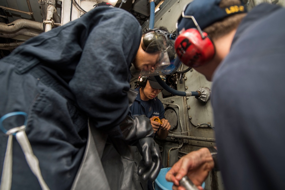 USS Rushmore Sailors sample diesel engine lube oil