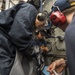 USS Rushmore Sailors sample diesel engine lube oil