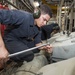USS Rushmore Sailors work on a main propulsion diesel engine