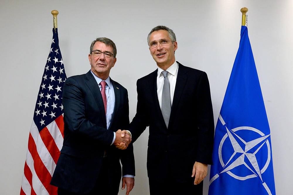 Secretary of defense shakes hands with NATO Secretary General Jens Stoltenberg